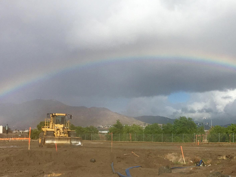 rainbow at construction site in valley